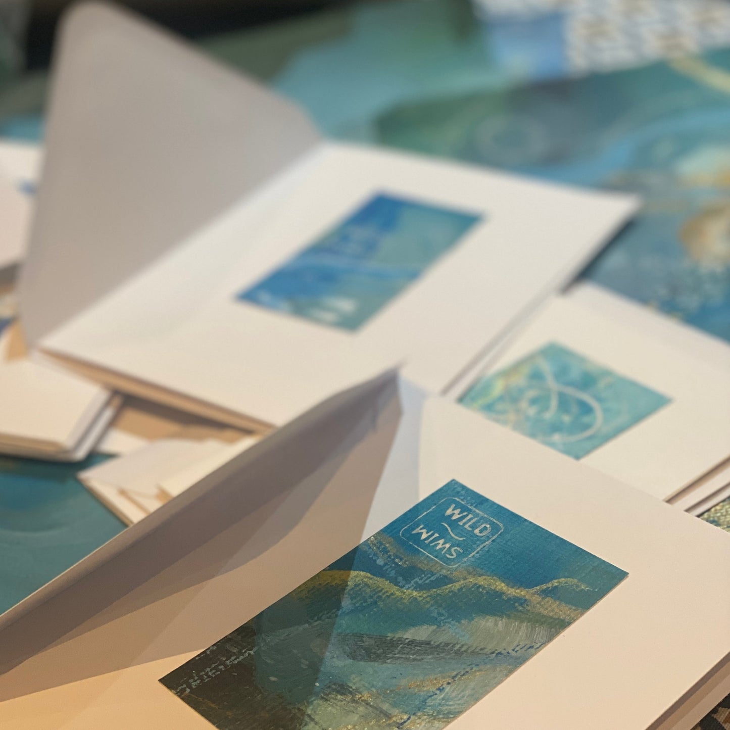 art cards for wild swimmers with blue painting snippets and wild swim stamp