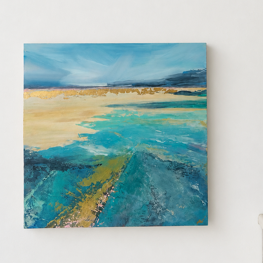An abstract landscape painting with blue, teal, and beige tones hanging on a white wall.